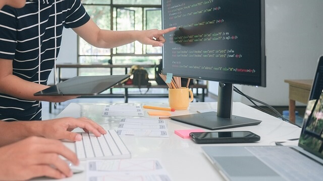 How to Learn Coding Online? Best Websites & Apps How to learn coding online. Young student learning coding online using laptop and mobile apps